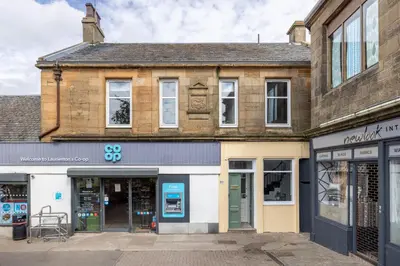 an old building on a street with shops at Antonine Quarters in Grahamston