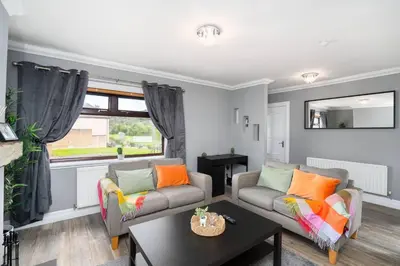 a living room with two couches and a table at Wardlaw Retreat-WiFi-Parking in Oakley