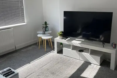 a living room with a large flat screen tv at Glasgow City Apartment with 2 Bedrooms in Glasgow
