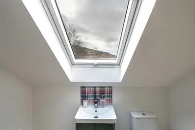 a skylight in a bathroom with a sink and a toilet at Strathfillan Lodge in Crianlarich
