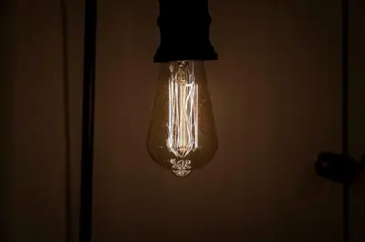 a light bulb hanging from a ceiling in a room at Couples or Golfers Near to Beach in Troon