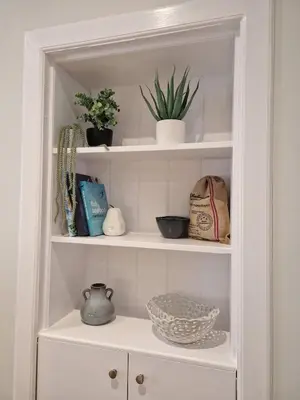 a white cabinet with some plants on it at City Residence Free Parking in Stirling