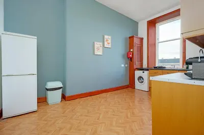 a kitchen with a refrigerator and a washer and dryer at Family and Group Stay 2BR by Park Sleeps 7 in Glasgow