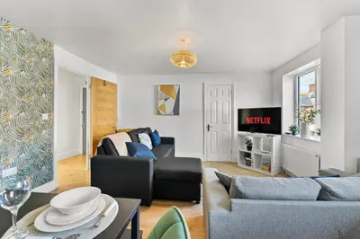 a living room with a couch and a table at Modern 2-Bed Apartment in Canterbury City Centre in Moffat
