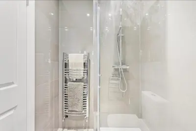 a white bathroom with a shower and a toilet at Modern 2-Bed Apartment in Canterbury City Centre in Moffat