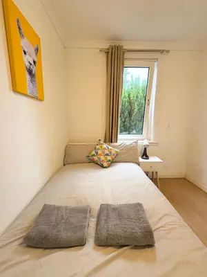 a bedroom with a bed with two pillows on it at Murrayfield Maindoor flat with Free parking and Great Public transports Link in Edinburgh