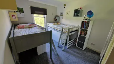 a small room with two beds and a bunk bed at Modern Three-Bedroom Apartment in Leafy West End with Private Parking in Glasgow