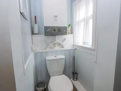 a small bathroom with a toilet and a window at Learig Lodge in Girvan