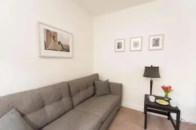 a living room with a couch and a table at Dalziel House-3 bedroom Hamilton in Hamilton