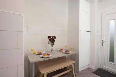 a small kitchen with a table with plates of food at Dalziel House-3 bedroom Hamilton in Hamilton