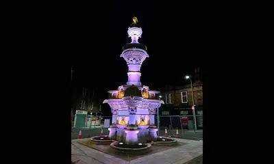 a purple monument in the middle of a street at night at 1 Bed Cosy Loch Lomond base in Bonhill