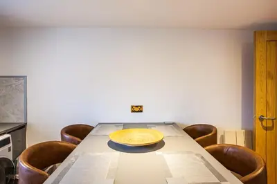 a dining room table with a yellow plate on it at Lochfyne-View Apartment in Inveraray