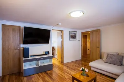 a living room with a large flat screen tv at Lochfyne-View Apartment in Inveraray