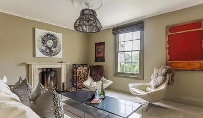 a living room with a glass table and two chairs at Gorgeous Georgian townhouse in Moffat