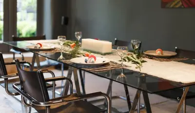a dining table with plates and wine glasses on it at Gorgeous Georgian townhouse in Moffat