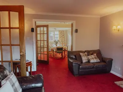 a living room with a couch and a table at 3 Bedroom Home, Peaceful Garden in Edinburgh