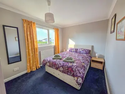 a bedroom with a bed and a window at 3 Bedroom Home, Peaceful Garden in Edinburgh