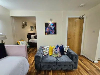 a living room with a couch and a bed at 2 bedroom, 4 beds -Grassmarket in Edinburgh