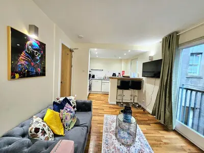 a living room with a couch and a kitchen at 2 bedroom, 4 beds -Grassmarket in Edinburgh