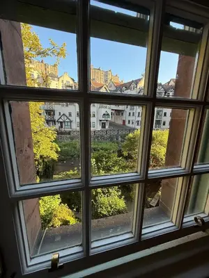 a window with a view of a city seen through it at Dean Village, Edinburgh in Edinburgh