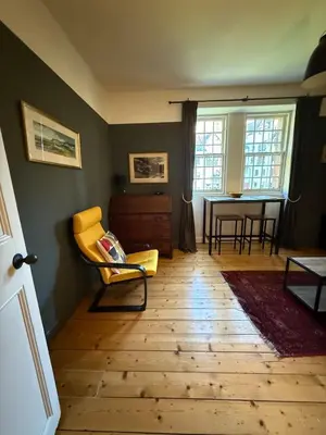 a living room with a yellow chair and a table at Dean Village, Edinburgh in Edinburgh
