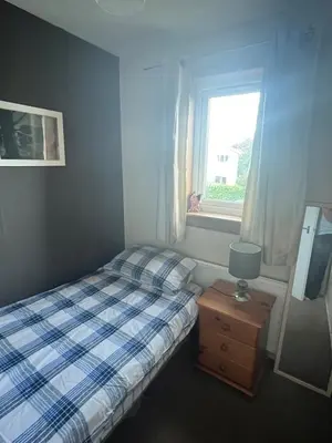 a small bedroom with a bed and a window at 3 bed self contained part house in Queensferry, Edinburgh in Queensferry