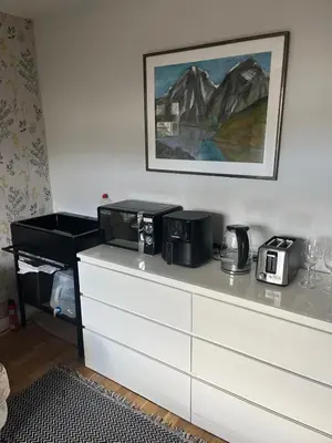 a white dresser with a microwave on top of it at 3 bed self contained part house in Queensferry, Edinburgh in Queensferry