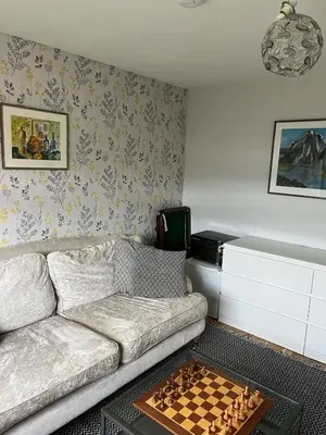 a living room with a couch and chessboard on a table at 3 bed self contained part house in Queensferry, Edinburgh in Queensferry