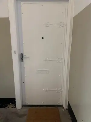 a white door with three handles on a wall at City Centre Ground floor 3 Bedroom Apartment in Edinburgh