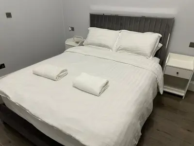 a large white bed with two white pillows on it at City Centre Ground floor 3 Bedroom Apartment in Edinburgh