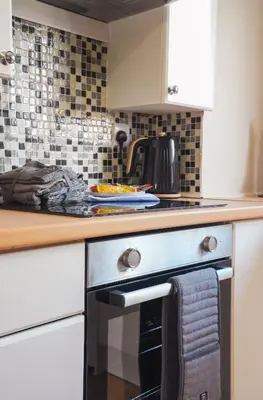 a kitchen with a stove and a counter top at North Elgin Apartment in Clydebank