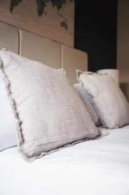 two pillows sitting on top of a bed at North Elgin Apartment in Clydebank
