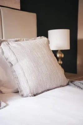 a white pillow sitting on top of a bed at North Elgin Apartment in Clydebank