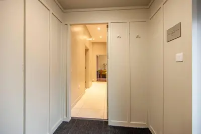 a hallway with white walls and a long corridor at Stylish 2Bedroom Flat - Central Oban in Oban