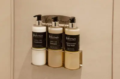 a group of three bottles of soap on a shelf at Stylish 2Bedroom Flat - Central Oban in Oban