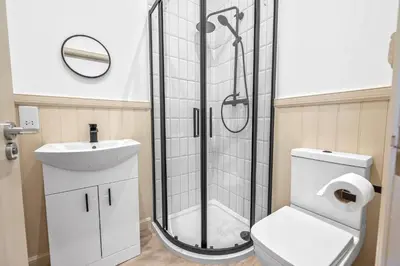 a bathroom with a shower and a toilet and a sink at Elegant 3BD Escape - Perfect Central Location in Oban