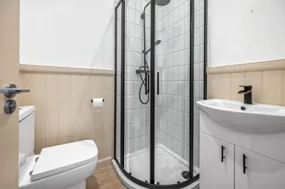 a bathroom with a shower and a toilet and a sink at Elegant 3BD Escape - Perfect Central Location in Oban