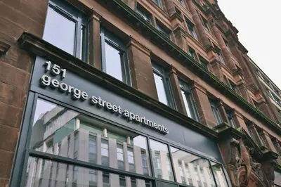 a store sign on the side of a building at For Students Only - George Street in Glasgow in Glasgow