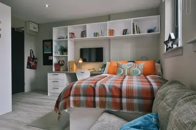 a bedroom with a bed and a desk in it at For Students Only - George Street in Glasgow in Glasgow