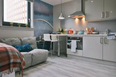 a kitchen with a couch and a table in a room at For Students Only - George Street in Glasgow in Glasgow