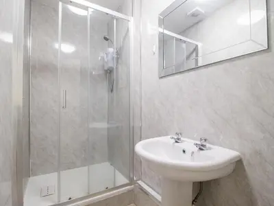 a white bathroom with a sink and a shower at Pass the Keys Cosy in Fabulous West End in Glasgow