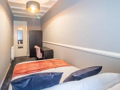 a small room with two beds and a desk at Pass the Keys Cosy in Fabulous West End in Glasgow