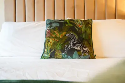 a pillow with a zebra on it on a bed at Group Stay 3BR Close to Hydro and SECC with Parking in Govan