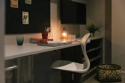 a white chair sitting at a desk in a room at For Students Only - Bath Street in Glasgow in Glasgow