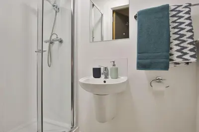 a white bathroom with a sink and a shower at For Students Only - Bath Street in Glasgow in Glasgow
