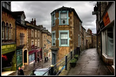 a city street with buildings and people walking down a street at Beechwood in Moffat