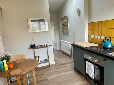 a kitchen with a table and a small table and a counter at Beechwood in Moffat