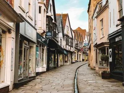 a cobblestone street in an old town with buildings at Beechwood in Moffat
