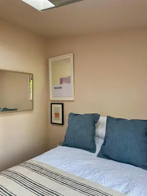 a bedroom with a bed with two blue pillows at Beechwood in Moffat