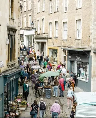 a group of people walking down a city street at Beechwood in Moffat